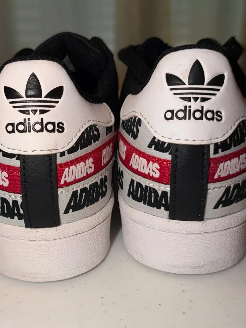 adidas Black & White Superstar Sneakers with Red Logo Tape